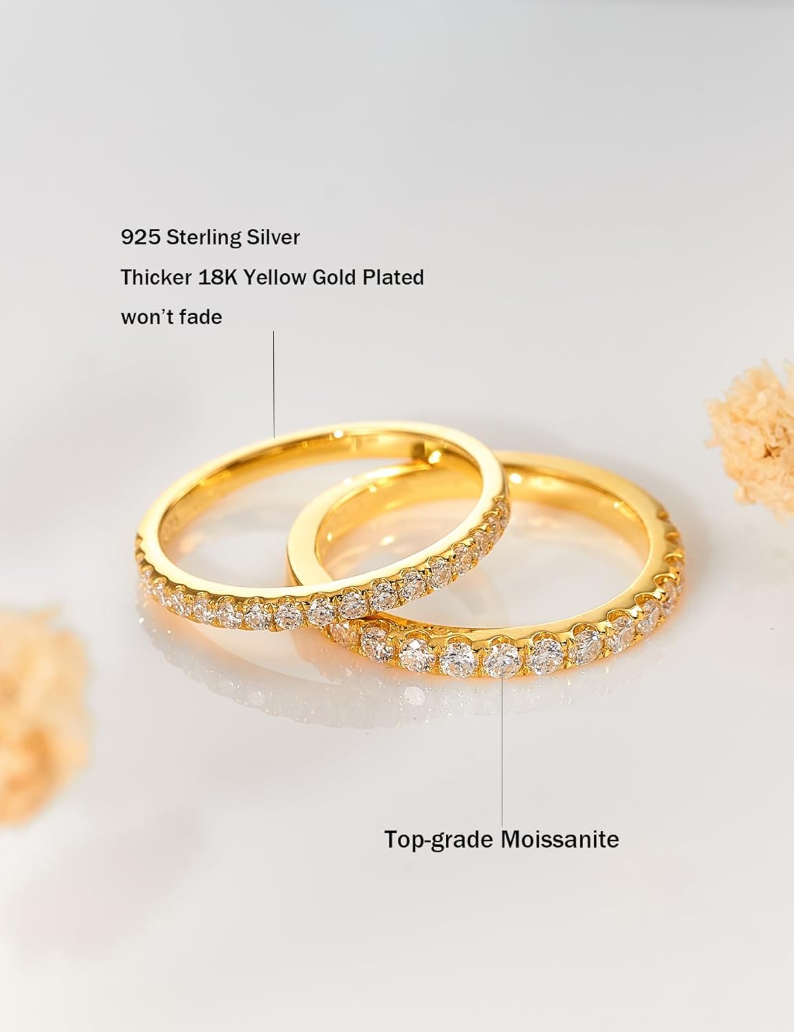 Gold-plated sterling silver moissanite rings with sparkling stones on a white background.